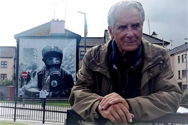 ICONIC... Clive Limpkin in front of one of the famous Bogside murals which was influenced by one of his photographs.