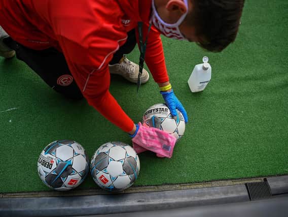 Footballs are being disinfected ahead of a Bundesliga match at  the weekend as German football puts into practice its medical protocols to reduce the risk of infection.