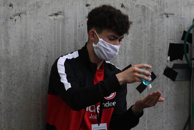 A ballboy uses sanitising gel during a Bundesliga match at the weekend.