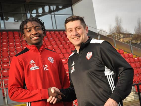 Defender, Danny Lupano pictured with Derry City boss, Declan Devine, has signed a contract extension with Hull City.