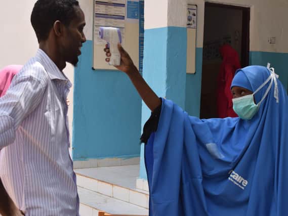 Habiba Mohamed, one of Trcaires health workers, checks the temperature of Mohamed Abdi Ali at Luuq hospital, in the Gedo region of Somalia.