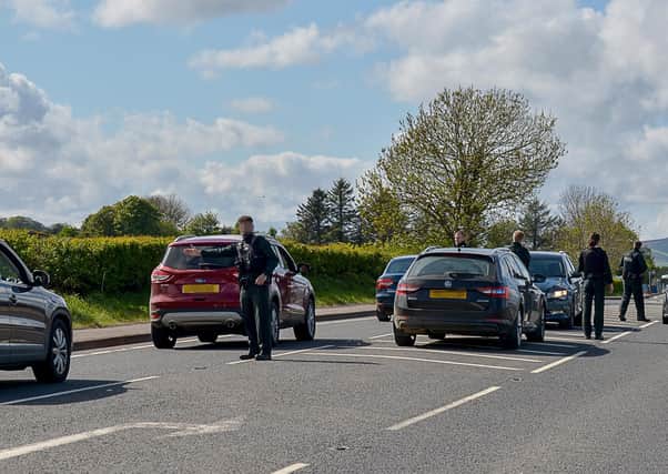 PSNI officers pictured at a vehicle checkpoint, engaging the public on Covid-19 guidelines, near the Derry to Bridgend border crossing earlier this month.  DER1920GS – 001