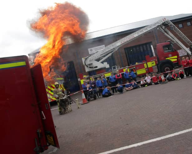 Local children previously being shown the dangers of a chip pan fire during an Open Day at Crescent Link Fire Station. DER2315MC062