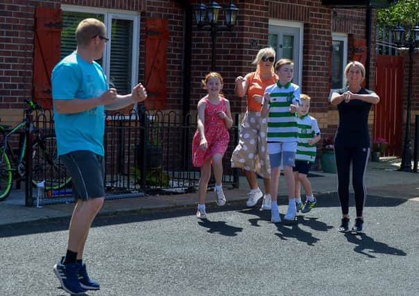 Families from Old City Close take part in Street Exercises, facilitated by the Brandywell and Bogside Health Forum, on Wednesday afternoon last. DER2220GS - 001