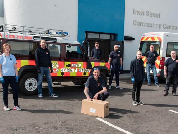 Alison Wallace from Waterside Neighbourhood Partnership pictured with members of Foyle Search and Rescue outside the main Waterside food distribution hub in Irish Street.
