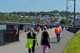 People exercise, in the sunshine, along the Foyle Embankment on Wednesday afternoon last. DER2220GS - 012