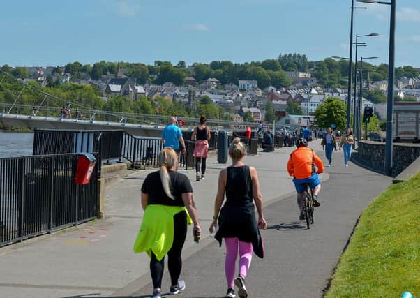 People exercise, in the sunshine, along the Foyle Embankment on Wednesday afternoon last. DER2220GS - 012