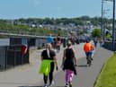 People exercise, in the sunshine, along the Foyle Embankment on Wednesday afternoon last. DER2220GS - 012
