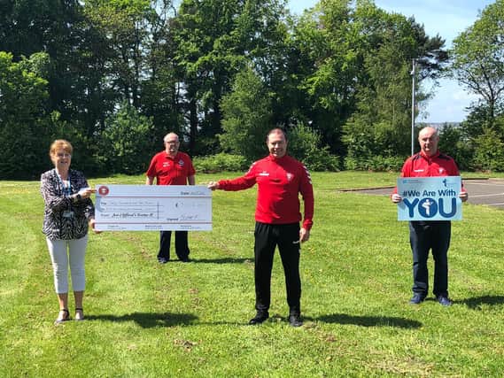 Tristar Boys' F.C. Secretary, Greg Parke and Club Chairman, Davy Thompson, present a cheque for the proceeds of the club's 'Stay Home and Shave Your Dome'  fundraiser to Western Health and Social Care Trust staff,Carol Doherty and Brendan Gormley.