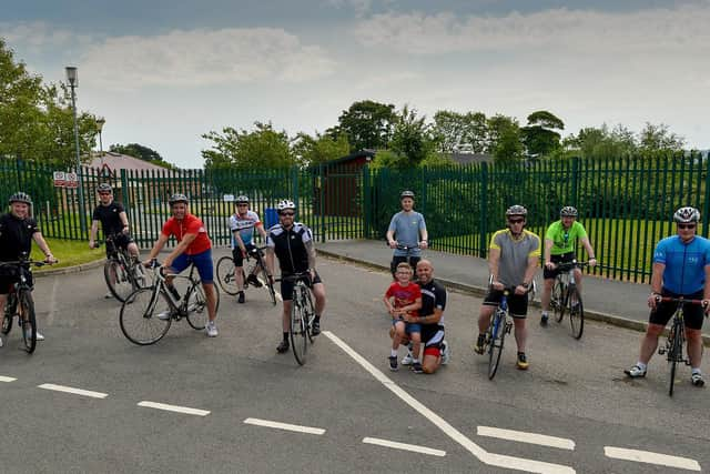 Pictured ahead of the start of their 90 day 16,000km bike challenge in aid of Ardnashee School and College is Martin McNutt with his son, Luca (8) (kneeling centre) and, from left to right, Ryan Magee, James McMonagle, Simon Collins, John OConnell, Dee OHara, Gary Curran, David Walker, Mark Crossan and Darren Boyle.