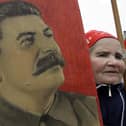A woman carries a portrait of the Soviet dictator Josef Stalin during a traditional Communist Party demonstration in downtown Moscow on Tuesday, May 1, 2007. Picture: Dmitry Lovetsky/AP