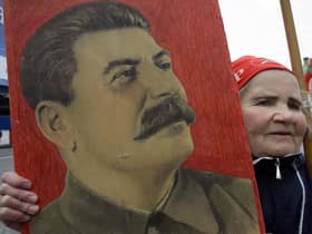 A woman carries a portrait of the Soviet dictator Josef Stalin during a traditional Communist Party demonstration in downtown Moscow on Tuesday, May 1, 2007. Picture: Dmitry Lovetsky/AP