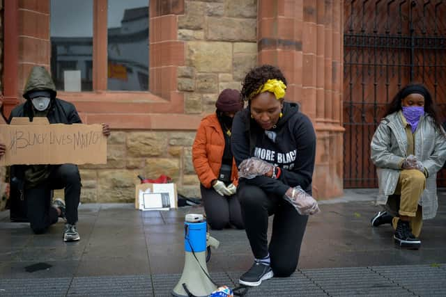 Lilian Seenoi- Barr, Director of Programmes at the The North West Migrants Forum taking a knee at the Justice for George Floyd rally held in Guildhall Square on Saturday afternoon last. DER2320GS – 035