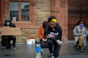 Lilian Seenoi- Barr, Director of Programmes at the The North West Migrants Forum taking a knee at the Justice for George Floyd rally held in Guildhall Square on Saturday afternoon last. DER2320GS – 035