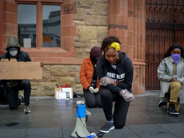 Lilian Seenoi- Barr, Director of Programmes at the The North West Migrants Forum taking a knee at the Justice for George Floyd rally held in Guildhall Square on Saturday afternoon last. DER2320GS – 035