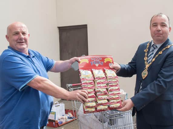 The Mayor Brian Tierney receives a gift of his favourite snack from Owney Boyle when he visited SCRA at Northside.
