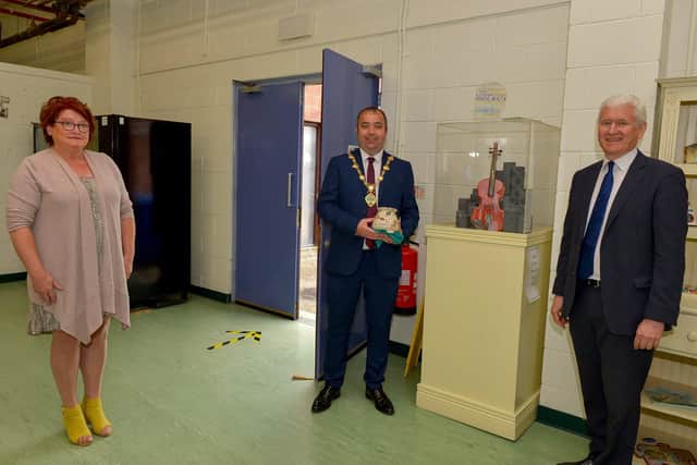 The Mayor of Derry and Strabane Colr. Brian Tierney receives a piece of pottery designed by Deidre o’Callaghan, Skills Coach with Action Mental Health New Horizons, during a visit to the facility yesterday morning. The charity is donating pottery pieces to key workers in the city. Included in the photo are Pauline Flangan, Service Manager and David Babington, CEO. DER2025GS - 054