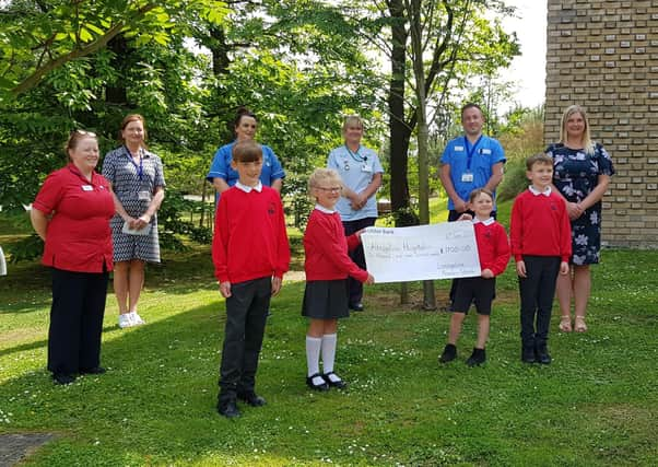 Pictured presenting the cheque front row are Lisnagelvin PS pupils Robbie and Ellie Lynch and Eli and Cilian Doherty along with their teacher Mrs Allison Buchan. Back row are Trauma & Orthopaedic Unit staff Mary Lafferty, Acting Nursing Services Manager; Rosin Kelly, Elective Orthopaedic Unit Manager; Sinead McDermott, Staff Nurse; Daphne Cuthbert, Health Care Assistant and Darren Colhoun, Health Care Assistant