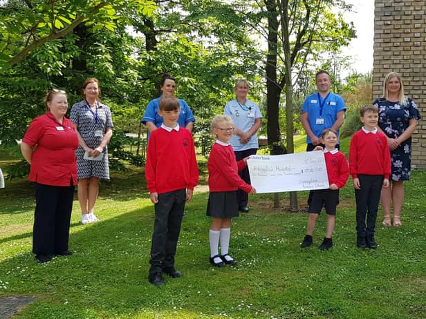 Pictured presenting the cheque front row are Lisnagelvin PS pupils Robbie and Ellie Lynch and Eli and Cilian Doherty along with their teacher Mrs Allison Buchan. Back row are Trauma & Orthopaedic Unit staff Mary Lafferty, Acting Nursing Services Manager; Rosin Kelly, Elective Orthopaedic Unit Manager; Sinead McDermott, Staff Nurse; Daphne Cuthbert, Health Care Assistant and Darren Colhoun, Health Care Assistant