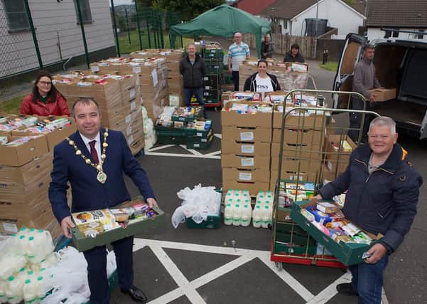 Mayor Brian Tierney with Min McCann, manager, Ballymagroarty Community Centre with staff and volunteers from BHCP at the Distribution of Food Parcels for the local area. (Photo - Tom Heaney, nwpresspics)