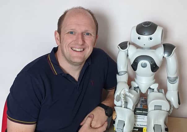 Ulster University's Dr Emmett Kerr the NAO robot who will be taking part in the Virtual Learning Festival next week.
