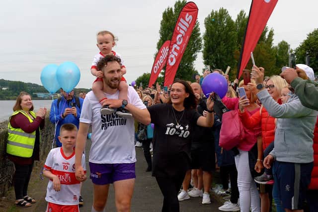 Danny Quigley’s partner Emear and sons Jack and Malachi accompany his on his arrival at Destined after completing a gruelling 10 Ironman Triathlons in 10 days in memory of his dad and fundraising over £100,000 for charities.  Photo: George Sweeney / Derry Journal.  DER2135GS – 020