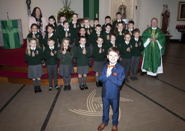 CHARLIE GETS HIS DAY!. . . . Greenhaw Primary Schoolâ€TMs Charlie Carton pictured on the occasion of his First Holy Communion at St. Brigidâ€TMs Church, Carnhill on Tuesday morning with his fellow pupils. Charlie wasnâ€TMt able to receive the Sacrament with his school mates in early September but the school pulled out all the stops to see he got his â€ ̃Big Dayâ€TM. Included in photo are Ms. McGrellis, class teacher and Fr. Gerard Mongan. (Photos: Jim McCafferty Photography)