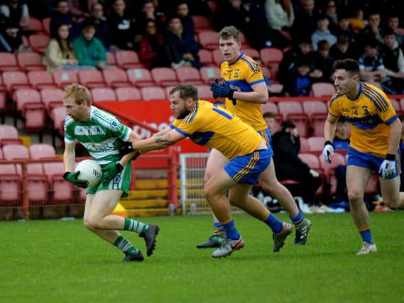 Limavady's Kieran McGlinchey grapples with Faughanvale's Conan Murray in Celtic Park on Sunday. (Photo: George Sweeney)