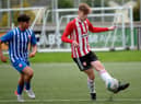Derry City’s Mattie Walker holds off Treaty United’s Jonathan Morgan during Sunday's Enda McGuill Cup semi-final. Picture by George Sweeney.