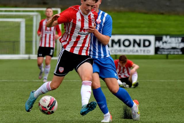 Derry City match winner Michael Harris holds off Treaty United's Cian Lynch. Picture by George Sweeney