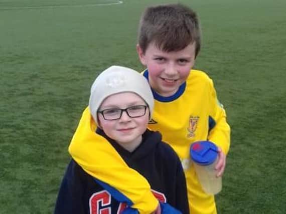 Liam pictured with younger brother Tadhg after playing a game for Clare U13s team about three years ago.