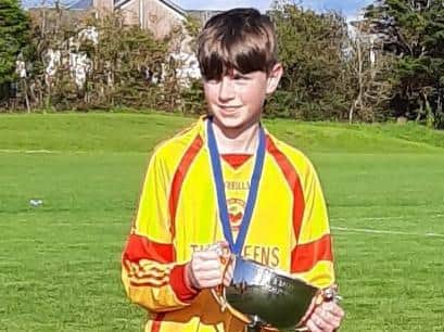 Liam pictured with the Clare Division One trophy last season. His team also won Division 1 at U13s in 2019.