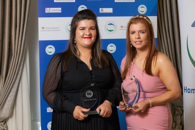 SISTERS OF MERCY . . . Joint winners of HCCI Carer of the Year award, Co Derry sisters Lauren and Chloe Kelly from Connected Health, pictured receiving their award during a ceremony at the Shelbourne Hotel in Dublin on Thursday, October 21. (Naoise Culhane)