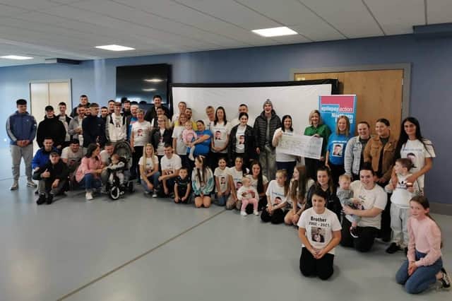 The family and friends  of the late Peter O’Hagan from Shantallow gather to present the money they raised through fundraising initiatives to Epilepsy Action  NI.