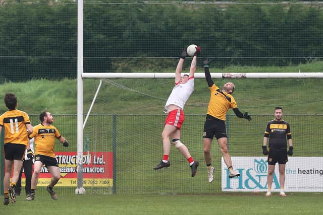Sean Dolans Eamon McGinley gets up above Stephen McGurk of Moneymore during the Derry JFC semi final. (Picture Margaret McLaughlin)