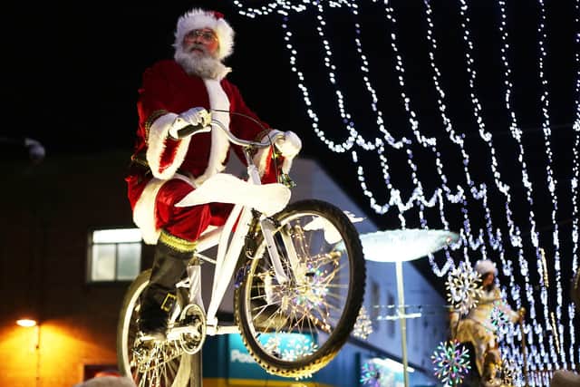 Santa on a bike at a previous Sound of Light Christmas Lights procession through Derry.  (Photo Lorcan Doherty Photography)