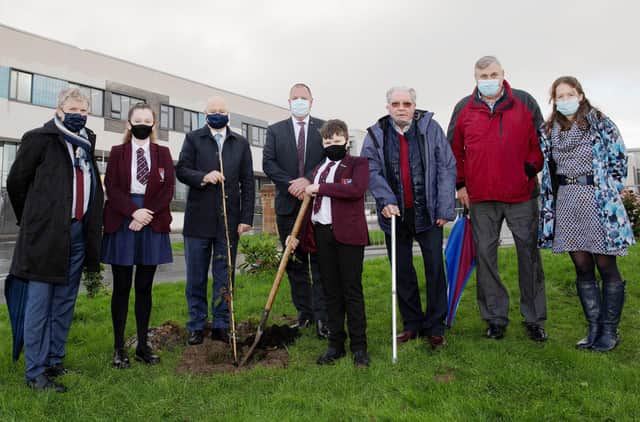 Professor Liam Maguire (UU), Kayla McDermott (Foyle College pupil), Professor Paul Bartholomew (UU), Patrick Allen (Principal, Foyle College), Kelvin McDermott (pupil), Dr Robert Murtland, William Lynn (teacher, Foyle College) and Nicole Sloane (teacher, Foyle College), with the newly plated tree at Foyle College.