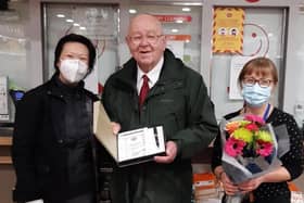 Post Office Network Provision Lead Janese Sung presenting a certificate and gifts to Jim Gough and his daughter Geraldine