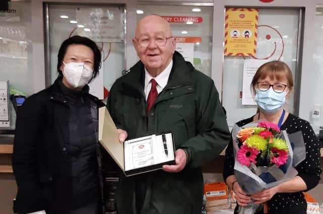 Post Office Network Provision Lead Janese Sung presenting a certificate and gifts to Jim Gough and his daughter Geraldine