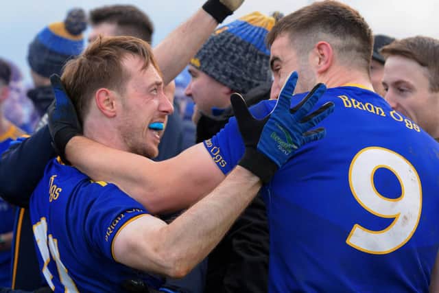 Steelstown captain Neil Forester and Ryan Devine celebrate winning the Intermediate Football Championship trophy on Saturday last in Ballymaguigan.  Photo: George Sweeney. DER2144GS – 029