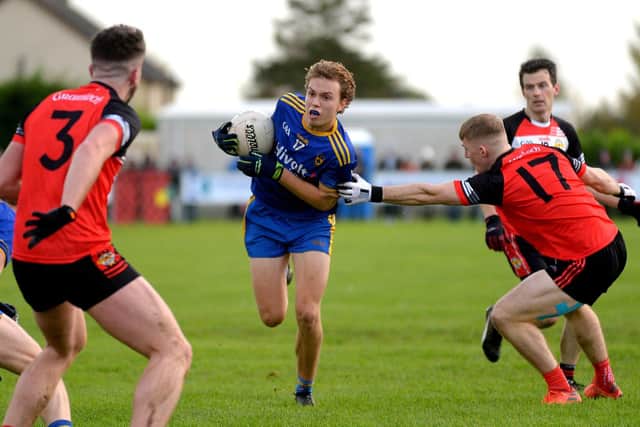 Steelstown’s Donnacha Gilmore holds possession under pressure from Greenlough’s Conor Mullan at Ballymaguigan on Saturday afternoon last. Photo: George Sweeney. DER2144GS – 042