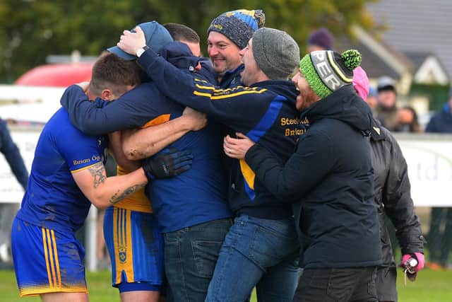 Steelstown players and coaches celebrate winning the Intermediate Football Championship trophy on Saturday last in Ballymaguigan. Photo: George Sweeney. DER2144GS – 036