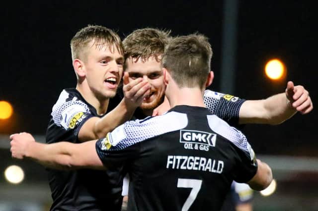 Derry City striker Jamie McGonigle celebrates his second goal with Ciaron Harkin and Will Fitzgerald. Photograph by Kevin Moore.