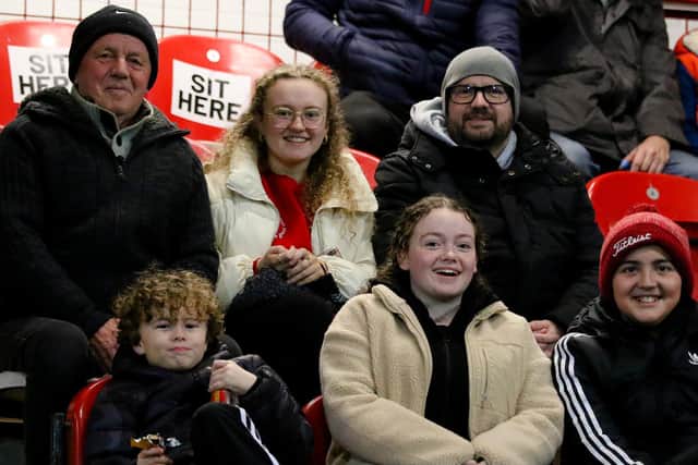 ALL SMILES  . . .   Derry City supporter Brian Heaney pictured with his son, Declan, and grandchildren at the Ryan McBride Brandywell Stadium on Friday night.
Photograph by Kevin Moore (Maiden City Images).