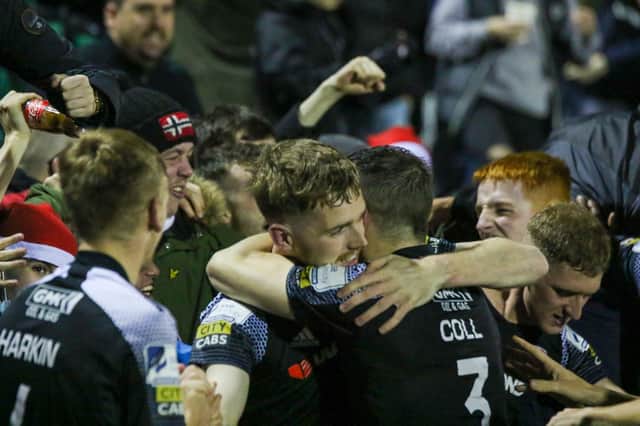 Derry City striker Jamie McGonigle celebrates with the travelling City support at Oriel Park after his second half goal gave the Candy Stripes the lead. Photograph by Kevin Moore (Maiden City Images)
