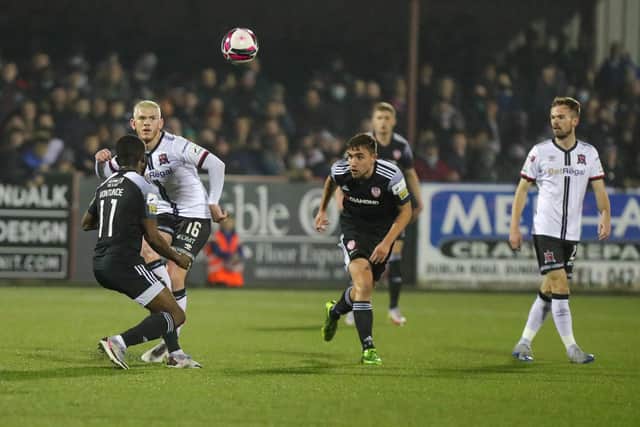 Dundalk goalscorer Sean Murray plays the ball over the top as James Akintunde and Joe Thomson look on at Oriel Park. Photo by Kevin Moore.