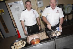John Jennings pictured on the morning of his retirement cooking breakfast for others in the office at Crescent Link Fire Station. On left is his son Noel. (Photos: Jim McCafferty Photography)