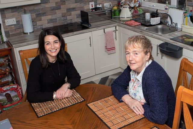 Tenant Moira Deeney, with Housing Executive patch manager Catherine Curran, in her new fitted kitchen at Gartan Square, Derry.