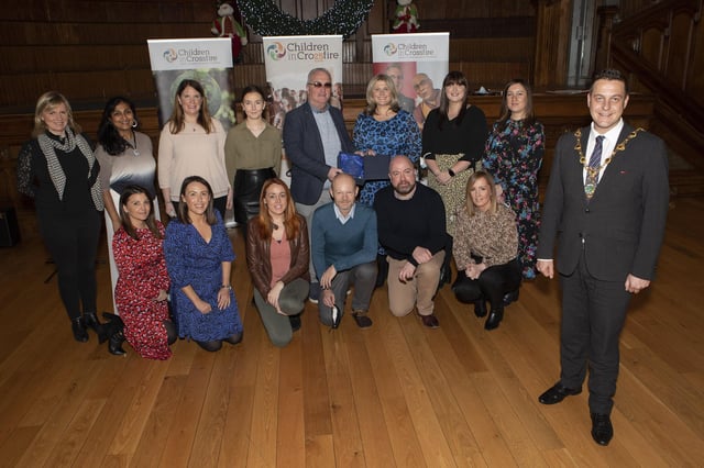 Mayor Graham Warke with volunteers and staff of Children in Crossfire at an event to mark the 25th anniversary of Children in Crossfire, held in the Guildhall.  (Photo - Tom Heaney, nwpresspics)