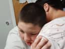 Ben O'Neill, 13, hugs his mother Ciara Gilliland